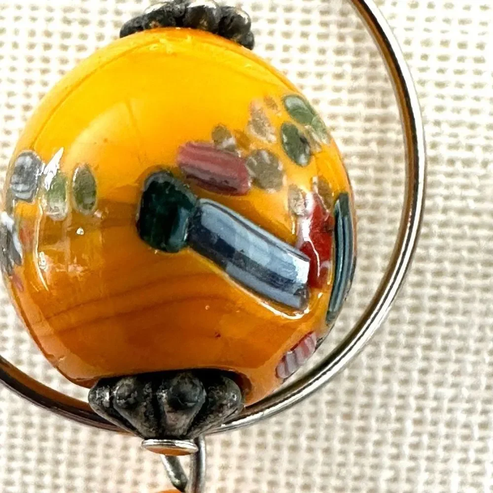 Silver tone orange beaded drop earrings